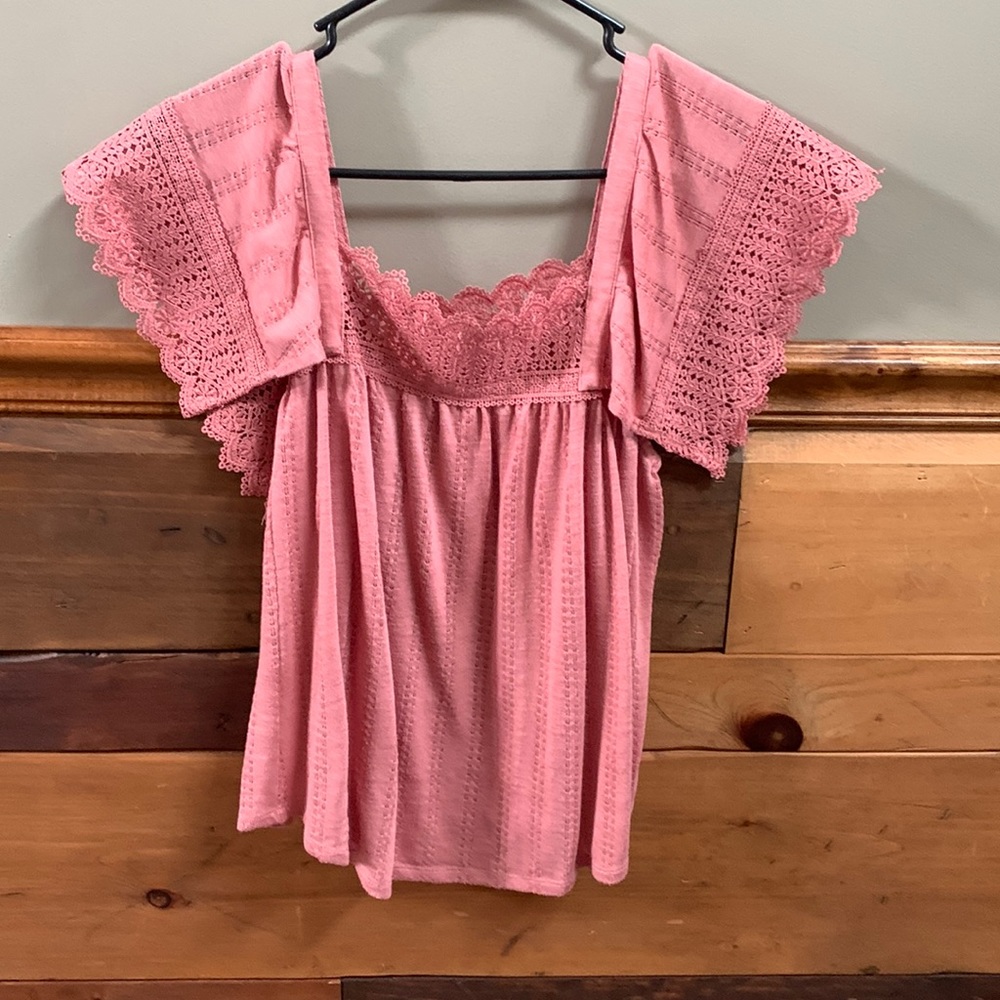 Pink blouse with Lacey sleeves.